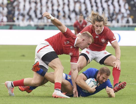Rugby World Cup in Japan: Italy v Canada Giulio Bisegni of Italy holds on to the ball under pressure from Canada s Ben LeSage (L) and Jeff Hassler during the first half of a Rugby World Cup Pool B on Sept. 26, 2019, in Fukuoka, southwestern Japan. 