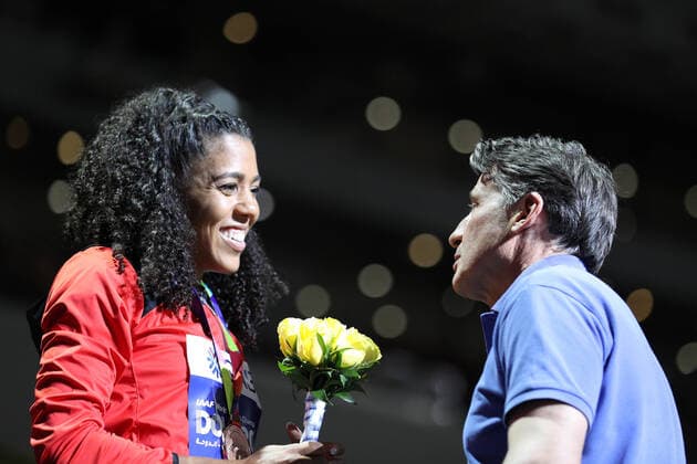 (191004) -- DOHA, Oct. 4, 2019 -- IAAF President Sebastian Coe (R) talks to bronze medalist Mujinga Kambundji of the Switzerland during the medal ceremony of the women s 200m at the 2019 IAAF World Championships in Doha, Qatar, Oct. 3, 2019. ) (SP)QATAR-DOHA-ATHLETICS-IAAF WORLD CHAMPIONSHIPS-MEDAL CEREMONY LixMing 