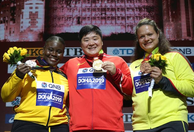 (191004) -- DOHA, Oct. 4, 2019 -- Gold medalist Gong Lijiao (C) of China, silver medalist Danniel Thomas-Dodd (L) of Jamaica and bronze medalist Christina Schwanitz of Germany pose for photos during the medal ceremony of the women s shot put at the 2019 IAAF World Athletics Championships in Doha, Qatar, on Oct. 4, 2019. ) (SP)QATAR-DOHA-IAAF WORLD ATHLETICS CHAMPIONSHIPS-MEDAL CEREMONY WangxJingqiang 