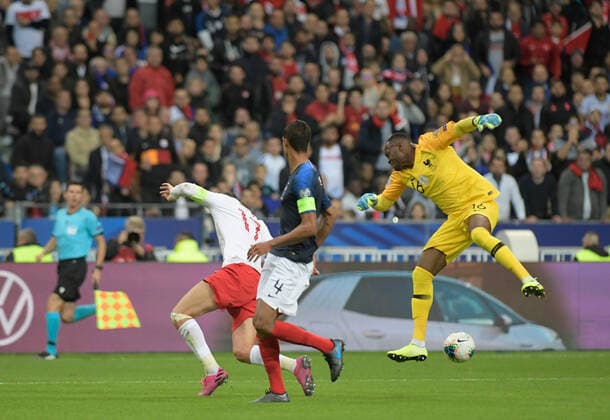 Burak Yilmaz of Turkey and Raphael Varane , Goalkeeper Steve Mandanda of France during the European Championship, EM, Europameisterschaft qualification Group H Match between France and Turkey at Stade de France in Saint-denis , France on October 14 , 2019. 
