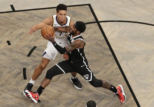 Brooklyn Nets Kyrie Irving drives to the basket defended by Indiana Pacers Malcolm Brogdon in the first half at Barclays Center on Wednesday, October 30, 2019 in New York City.  NYP20191030136 JOHNxANGELILLO