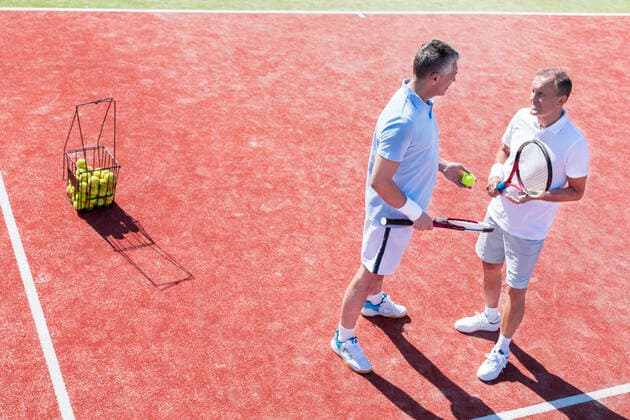 full length, Freisteller of men talking while standing on tennis court during match INH_19064_13211