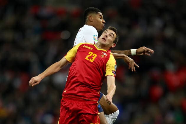 14th November 2019; Wembley Stadium, London, England; European Championships 2020 Qualifier, England versus Montenegro; Marcus Rashford of England and Branislav Jankovic of Montenegro battle for the ball - Editorial Use  ActionPlus12187940 ShaunxBrooks