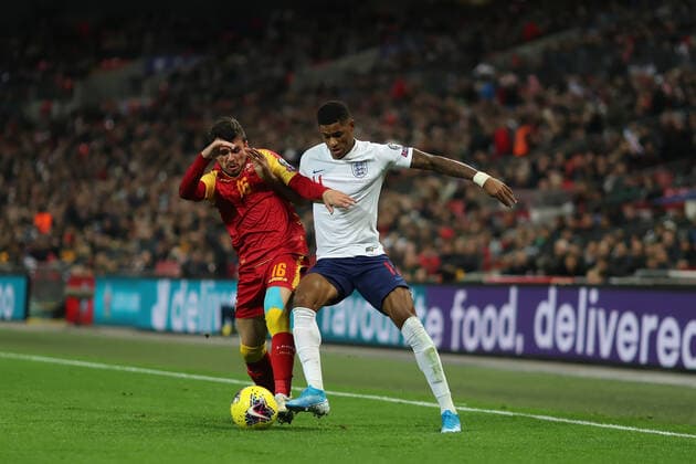 14th November 2019; Wembley Stadium, London, England; European Championships 2020 Qualifier, England versus Montenegro; Marcus Rashford of England competes for the ball with Vladimir Jovovic of Montenegro - Editorial Use  ActionPlus12187943 ShaunxBrooks