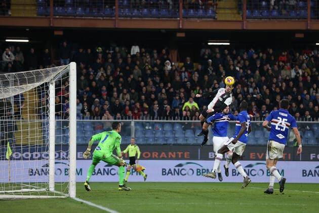 Cristiano Ronaldo of Juventus climbs above Nicola Murru of Sampdoria to head the ball past Emil Audero in the Sampdoria to give the side a 2-1 lead during the Serie A match at Luigi Ferraris, Genoa. Picture date: 18th December 2019. Picture credit should read: Jonathan Moscrop Sportimage EDITORIAL USE ONLY. No use with unauthorised audio, video, data, fixture lists, club league logos or live services. Online in-match use limited to 120 images, no video emulation. No use in betting, games or single club league player publications. SPI-0378-0020