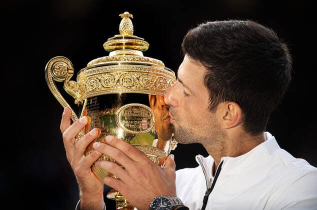 191220 This picture is part of Bildbyran?s selection of the 100 best sports photos from 2019. Originally published 20190714 Novak Djokovic of Serbia kisses the Men s Singles Trophy after winning Men s Singles final during day 13 of Wimbledon on July 14, 2019 in London, Great Britain. Photo: Joel Marklund Bildbyran for AELTC kod JM 87988 bbeng wimbledon wimbledon 2019 tennis topx jubel Copyright: JOELxMARKLUND BB191220JM020