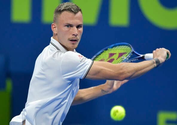 (200110) -- DOHA, Jan. 10, 2020 (Xinhua) -- Marton Fucsovics of Hungary returns the ball during the singles quarterfinal match against Miomir Kecmanovic of Serbia at ATP, Tennis Herren Qatar Open tennis tournament in Doha, Qatar, Jan. 9, 2020. (Photo by Nikku Xinhua) (SP)QATAR-DOHA-ATP-TENNIS-QATAR OPEN 