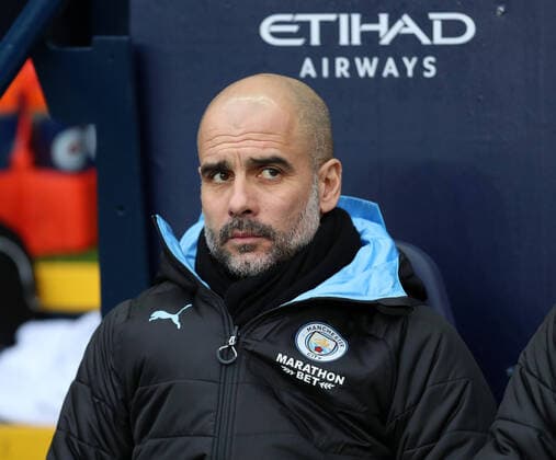 26th January 2020; Etihad Stadium, Manchester, Lancashire, England; English FA Cup Football, Manchester City versus Fulham; Manchester City manager Pep Guardiola looks on from the dugout - Strictly Editorial Use Only. No use with unauthorized audio, video, data, fixture lists, club league logos or live services. Online in-match use limited to 120 images, no video emulation. No use in betting, games or single club league player publications ActionPlus12206912 DavidxBlunsden