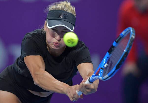 (200227) -- DOHA, Feb. 27, 2020 (Xinhua) -- Yulia Putintseva of Kazakhstan hits a return during the women s singles third round match against Belinda Bencic of Switzerland at the 2020 WTA, Tennis Damen Qatar Open in Doha, Qatar, Feb. 26, 2020. (Photo by Nikku Xinhua) (SP)QATAR-DOHA-TENNIS-WTA-SINGLES 