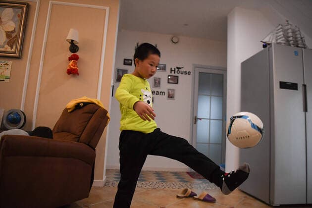 (200316) -- CHANGSHA, March 16, 2020 -- Lu Shu, Wu Yu s son, juggles the ball at home in Changsha, central China s Hunan Province on March 16, 2020. Wu Yu is a nurse from the third batch of medical teams from Xiangya Hospital to the coronavirus-hit Hubei Province. After a busy day on duty on March 8, Wu was asked if she had a wish for Women s Day, and gave what she felt was an ambitious response. I believe a jersey from Messi would definitely encourage my boy to become a member of the national youth training team, she said. The official Weibo account of Argentina s national football team responded on the very night and sent the gift to Lu Shu on March 16 to make her wish come true. ) (SP)CHINA-CHANGSHA-COVID-19-MESSI S JERSEY (CN) XuexYuge 