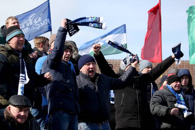 MINSK REGION, BELARUS - MARCH 22, 2020: Fans watch a 2020 Belarusian Football Cup match between FC Slutsk and Slavia Mazyr at the City Stadium in the town of Slutsk. The Belarusian Football Federation has decided not to cancel the new season of the tournament amid the COVID-19 coronavirus pandemic. Natalia Fedosenko TASS  TS0D3081