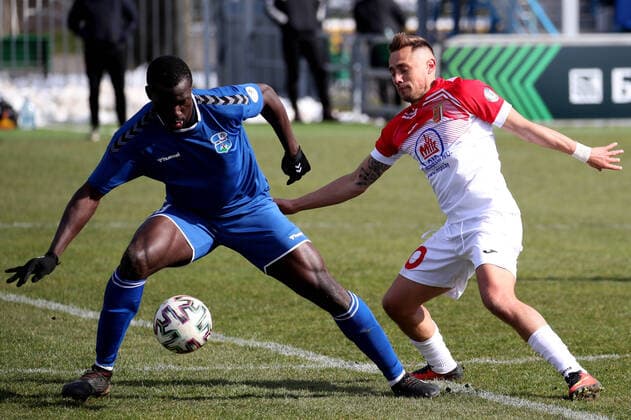 MINSK REGION, BELARUS - MARCH 22, 2020: FC Slutsk s Souleymane Koanda (L) and Slavia Mazyr s Andrey Chukhley in action in a 2020 Belarusian Football Cup match between FC Slutsk and Slavia Mazyr at the City Stadium in the town of Slutsk. The Belarusian Football Federation has decided not to cancel the new season of the tournament amid the COVID-19 coronavirus pandemic. Natalia Fedosenko TASS  TS0D3083
