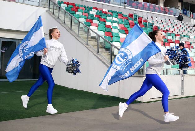 MINSK, BELARUS - APRIL 3, 2020: Dinamo Minsk cheerleaders with flags run onto the pitch after the first half of a 2020 Belarusian Premier League Round 3 football match between Dinamo Minsk and Torpedo-Belaz Zhodino at Dinamo Stadium. The Football Federation of Belarus has decided not to postpone the national football championship in connection with the pandemic of the novel coronavirus, with the 30th season of the Belarusian Premier League starting as scheduled on 19 March 2020. Dinamo Minsk won the match 2-0. Natalia Fedosenko TASS  TS0D4602