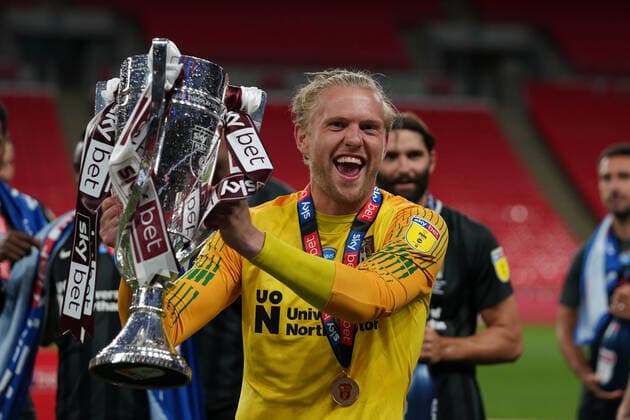 Goalkeeper David Cornell of Northampton Town celebrates promotion to League One with the trophy after a 4-0 victory in the Sky Bet League 2 PLAY-OFF Final match between Exeter City and Northampton Town at Wembley Stadium, London, England on 29 June 2020. Copyright: xAndyxRowlandx PMI-3511-0137