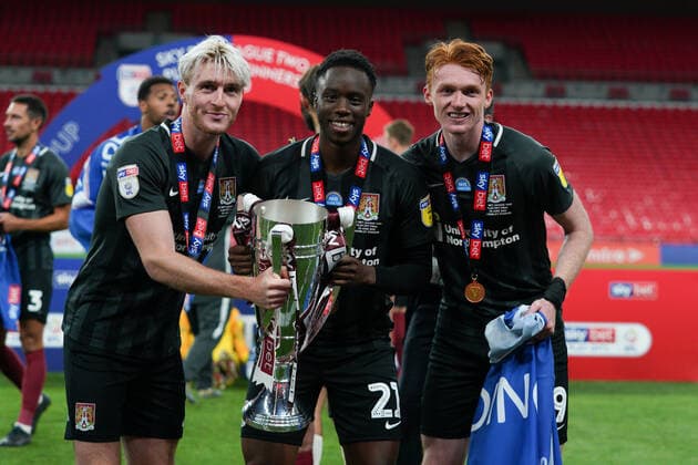 Ryan Watson, James Olayinka (on loan from Arsenal) and Callum Morton (on loan from WBA) of Northampton Town celebrate promotion to League One with the trophy after a 4-0 victory in the Sky Bet League 2 PLAY-OFF Final match between Exeter City and Northampton Town at Wembley Stadium, London, England on 29 June 2020. Copyright: xAndyxRowlandx PMI-3511-0142