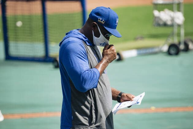 Kansas City Royals hitting coach Terry Bradshaw reviews stats while tugging on his mask at the start of a Summer Camp training workout at Kaufman Stadium in Kansas City, Missouri on Friday, July 3, 2020. Major League Baseball is finally starting their 2020 season after the COVID-19 pandemic caused months of delays.  KCP20200703106 KYLExRIVAS