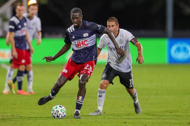 July 26, 2020, Orlando, FL, USA: ORLANDO, FL - JULY 25: New England Revolution midfielder Wilfried Zahibo (23) passes the ball away from Philadelphia Union midfielder Alejandro Bedoya (11) during the soccer match between the Philadelphia Union and the New England Revolution on July 25, 2020, at ESPN Wide World of Sports Complex in Orlando, FL. ( Icon Sportswire) Orlando USA - ZUMAi88_ 20200726_zaf_i88_001 Copyright: xJoexPetrox