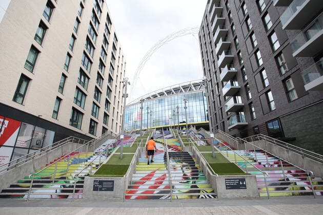 A man walks up the steps outside Wembley at the Emirates FA Cup Final match Arsenal v Chelsea, at Wembley Stadium, London, UK on 1st August, 2020. The match is being played behind closed doors because of the current COVID-19 Coronavirus pandemic, and government social distancing lockdown restrictions. 