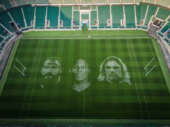The pitch at Twickenham Stadium has been transformed into a stunning portrait featuring three of Premiership Rugby?s star players today (12th August 2020). The giant rugby art, the largest outdoor painting ever created in the UK, was unveiled to celebrate the restart of Gallagher Premiership Rugby on Friday 14 th August when Harlequins take on Sale Sharks at 7:45pm, just 200 metres away. The artwork features Harlequins player, Joe Marler; Saracens? Maro Itoje, as well as Sale Sharks? Rugby World Cup winner Faf de Klerk. It took team of eight artists more than 24 hours to complete the pitch portrait and more than 100 hours of planning before any paint touched the grass. A bespoke computer program was written to generate the precise measurements that were needed to create the artwork to the exact scale of the stadium. The image, which occupies most of the 7,000 square metre pitch, was created using a grid comprised of 13,420 elements. Each painted line in the portrait is just 6 inches wide. Nearly 1280 litres of biodegradable pitch marker paint were used for the elaborate creation. An estimated 150,000 passengers will enjoy the spectacle from the sky this week on flights in and out of London?s Heathrow airport. Faf de Klerk was one of the featured Premiership Rugby stars in the portrait. The Sale Sharks star said, I didn t realise it was going to be on the field, I thought it was going to be a photo up somewhere or on the big screen. It s looking really cool. There are a lot of great players in the Premiership, and it is amazing. I feel really privileged and quite humble . Speaking about the impact of lockdown on the Saracens star Maro Itoje said The last few months have been really tough on fans and players but we?re back and we?re ready for the start of the season on Friday 14th August. The past five months has shown us how important the sport is and what it brings to people lives. British artist John Lundberg, who oversaw the po Copyright: xScottxGarfitt PinPep CoverxImagesx 0103040073st EDITORIAL USE ONLY. RESTRICTED TO NEWSPAPERS BASED IN THE UK