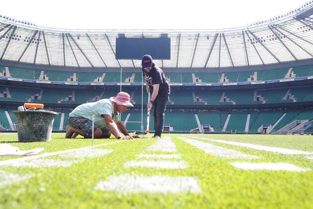 The pitch at Twickenham Stadium has been transformed into a stunning portrait featuring three of Premiership Rugby?s star players today (12th August 2020). The giant rugby art, the largest outdoor painting ever created in the UK, was unveiled to celebrate the restart of Gallagher Premiership Rugby on Friday 14 th August when Harlequins take on Sale Sharks at 7:45pm, just 200 metres away. The artwork features Harlequins player, Joe Marler; Saracens? Maro Itoje, as well as Sale Sharks? Rugby World Cup winner Faf de Klerk. It took team of eight artists more than 24 hours to complete the pitch portrait and more than 100 hours of planning before any paint touched the grass. A bespoke computer program was written to generate the precise measurements that were needed to create the artwork to the exact scale of the stadium. The image, which occupies most of the 7,000 square metre pitch, was created using a grid comprised of 13,420 elements. Each painted line in the portrait is just 6 inches wide. Nearly 1280 litres of biodegradable pitch marker paint were used for the elaborate creation. An estimated 150,000 passengers will enjoy the spectacle from the sky this week on flights in and out of London?s Heathrow airport. Faf de Klerk was one of the featured Premiership Rugby stars in the portrait. The Sale Sharks star said, I didn t realise it was going to be on the field, I thought it was going to be a photo up somewhere or on the big screen. It s looking really cool. There are a lot of great players in the Premiership, and it is amazing. I feel really privileged and quite humble . Speaking about the impact of lockdown on the Saracens star Maro Itoje said The last few months have been really tough on fans and players but we?re back and we?re ready for the start of the season on Friday 14th August. The past five months has shown us how important the sport is and what it brings to people lives. British artist John Lundberg, who oversaw the po Copyright: xScottxGarfitt PinPep CoverxImagesx 0103040125st EDITORIAL USE ONLY. RESTRICTED TO NEWSPAPERS BASED IN THE UK