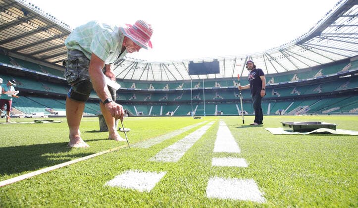 The pitch at Twickenham Stadium has been transformed into a stunning portrait featuring three of Premiership Rugby?s star players today (12th August 2020). The giant rugby art, the largest outdoor painting ever created in the UK, was unveiled to celebrate the restart of Gallagher Premiership Rugby on Friday 14 th August when Harlequins take on Sale Sharks at 7:45pm, just 200 metres away. The artwork features Harlequins player, Joe Marler; Saracens? Maro Itoje, as well as Sale Sharks? Rugby World Cup winner Faf de Klerk. It took team of eight artists more than 24 hours to complete the pitch portrait and more than 100 hours of planning before any paint touched the grass. A bespoke computer program was written to generate the precise measurements that were needed to create the artwork to the exact scale of the stadium. The image, which occupies most of the 7,000 square metre pitch, was created using a grid comprised of 13,420 elements. Each painted line in the portrait is just 6 inches wide. Nearly 1280 litres of biodegradable pitch marker paint were used for the elaborate creation. An estimated 150,000 passengers will enjoy the spectacle from the sky this week on flights in and out of London?s Heathrow airport. Faf de Klerk was one of the featured Premiership Rugby stars in the portrait. The Sale Sharks star said, I didn t realise it was going to be on the field, I thought it was going to be a photo up somewhere or on the big screen. It s looking really cool. There are a lot of great players in the Premiership, and it is amazing. I feel really privileged and quite humble . Speaking about the impact of lockdown on the Saracens star Maro Itoje said The last few months have been really tough on fans and players but we?re back and we?re ready for the start of the season on Friday 14th August. The past five months has shown us how important the sport is and what it brings to people lives. British artist John Lundberg, who oversaw the po Copyright: xScottxGarfitt PinPep CoverxImagesx 0103040131st EDITORIAL USE ONLY. RESTRICTED TO NEWSPAPERS BASED IN THE UK