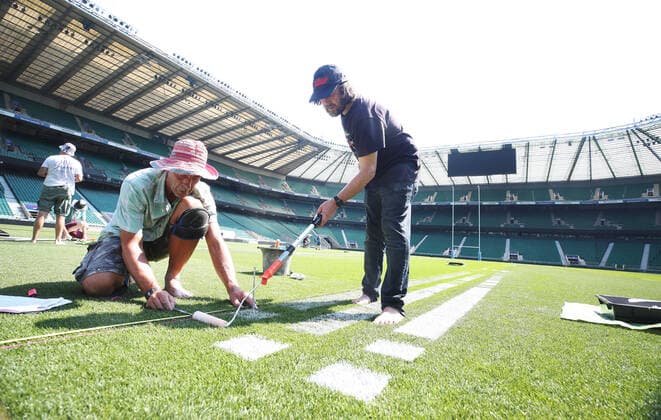 The pitch at Twickenham Stadium has been transformed into a stunning portrait featuring three of Premiership Rugby?s star players today (12th August 2020). The giant rugby art, the largest outdoor painting ever created in the UK, was unveiled to celebrate the restart of Gallagher Premiership Rugby on Friday 14 th August when Harlequins take on Sale Sharks at 7:45pm, just 200 metres away. The artwork features Harlequins player, Joe Marler; Saracens? Maro Itoje, as well as Sale Sharks? Rugby World Cup winner Faf de Klerk. It took team of eight artists more than 24 hours to complete the pitch portrait and more than 100 hours of planning before any paint touched the grass. A bespoke computer program was written to generate the precise measurements that were needed to create the artwork to the exact scale of the stadium. The image, which occupies most of the 7,000 square metre pitch, was created using a grid comprised of 13,420 elements. Each painted line in the portrait is just 6 inches wide. Nearly 1280 litres of biodegradable pitch marker paint were used for the elaborate creation. An estimated 150,000 passengers will enjoy the spectacle from the sky this week on flights in and out of London?s Heathrow airport. Faf de Klerk was one of the featured Premiership Rugby stars in the portrait. The Sale Sharks star said, I didn t realise it was going to be on the field, I thought it was going to be a photo up somewhere or on the big screen. It s looking really cool. There are a lot of great players in the Premiership, and it is amazing. I feel really privileged and quite humble . Speaking about the impact of lockdown on the Saracens star Maro Itoje said The last few months have been really tough on fans and players but we?re back and we?re ready for the start of the season on Friday 14th August. The past five months has shown us how important the sport is and what it brings to people lives. British artist John Lundberg, who oversaw the po Copyright: xScottxGarfitt PinPep CoverxImagesx 0103040132st EDITORIAL USE ONLY. RESTRICTED TO NEWSPAPERS BASED IN THE UK