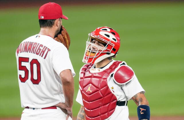 St. Louis Cardinals catcher Yadier Molina talks to starting pitcher Adam Wainwright during the third inning against the Kansas City Royals at Busch Stadium in St. Louis on Tuesday, August 25, 2020.  SLP2020082513 BILLxGREENBLATT