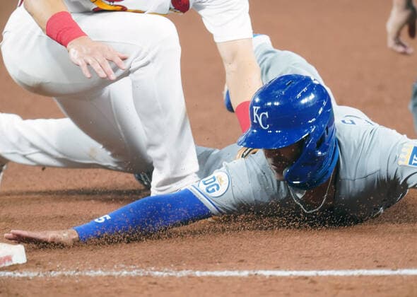 Kansas City Royals Whit Merrifield is tagged out at third base by St. Louis Cardinals Tommy Edman in the fifth inning at Busch Stadium in St. Louis on Tuesday, August 25, 2020.  SLP2020082521 BILLxGREENBLATT