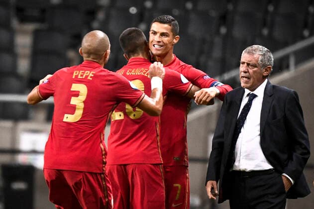 Portugal s Christiano Ronaldo is congratulated on his 100th goal by Pepe and Joao Cancelo and national team, Nationalteam captain Fernando Santo during the UEFA Nations League, division A, group 3 soccer game betwween Sweden and Portugal at Friends Arena in Stockholm, Sweden, on Sept. 08, 2020. Photo Claudio Bresciani TT kod 10090 *SWEDEN OUT* Stockholm Sweden SOCCER x10090x