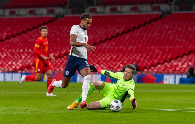 (201009) -- LONDON, Oct. 9, 2020 () -- England s Dominic Calvert-Lewin (L) vies with Wales goalkeeper Wayne Hennessey during a friendly match between England and Wales in London, Britain, on Oct. 8, 2020. () (SP) BRITAIN-LONDON-FOOTBALL-FRIENDLY MATCH-ENGLAND VS WALES Xinhua 