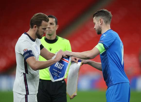 Harry Kane of England and Kari Arnason of Iceland exchange gifts during the UEFA Nations League match at Wembley Stadium, London. Picture date: 18th November 2020. Picture credit should read: David Klein Sportimage EDITORIAL USE ONLY. No use with unauthorised audio, video, data, fixture lists, club league logos or live services. Online in-match use limited to 120 images, no video emulation. No use in betting, games or single club league player publications. SPI-0760-0012