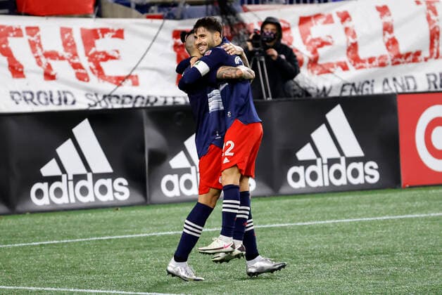 FOXBOROUGH, MA - NOVEMBER 20: New England Revolution forward Carles Gil (22) hugs New England Revolution forward Gustavo Bou (7) after his stoppage time winner during an MLS, Fussball Herren, USA Cup Play-In game between the New England Revolution and the Montreal Impact on November 20, 2020, at Gillette Stadium in Foxborough, Massachusetts. (Photo by Fred Kfoury III Icon Sportswire) SOCCER: NOV 20 MLS Cup Playoffs Eastern Conference Play-In - Montreal Impact at New England Revolution Icon482201120055