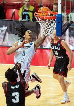 (201209) -- VILNIUS, Dec. 9, 2020 -- Kyle Allman (C) of VEF Riga shoots the basket during the Europe Basketball Champions League regular season group E match between Rytas Vilnius and VEF Riga in Vilnius, Lithuania, on Dec. 8, 2020. (Photo by Xinhua) (SP)LITHUANIA-VILNIUS-BASKETBALL-EUROPE CHAMPIONS LEAGUE AlfredasxPliadis 