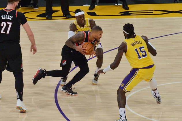 Portland Trail Blazers Damian Lillard drives to the basket against Los Angeles Lakers Dennis Schroder and Montrezi Harrell during the second half at Staples Center in Los Angeles on Monday, December 28, 2020. The Trail Blazers defeated the Lakers 115-107.  LAP2020122808 JIMxRUYMEN