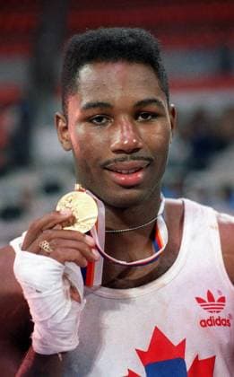 October 2, 1988, Seoul, South Korea: Canadian boxer Lennox Lewis displays his gold medal following the Olympic boxing final in Seoul, South Korea, Oct. 2, 1988. The physical gifts that helped boxer Lennox Lewis reach his s greatest heights are obvious when looking at his chiselled frame. It was mental strength that left him feeling particularly proud of his accomplishments showcased in the career-spanning documentary, Lennox Lewis: The Untold Story. LEWIS  - ZUMAc35_ 19881002_zaf_c35_001 Copyright: xRyanxRemiorzx