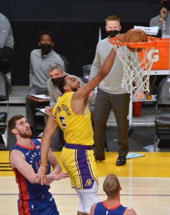 Los Angeles Lakers guard dunks on Detroit Pistons guard Svi Mykhailiuk during the third quarter at Staples Center in Los Angeles on Saturday, February 6, 2021. The Lakers defeated the Pistons 135-129 in double-overtime.  LAP2021020620 JIMxRUYMEN