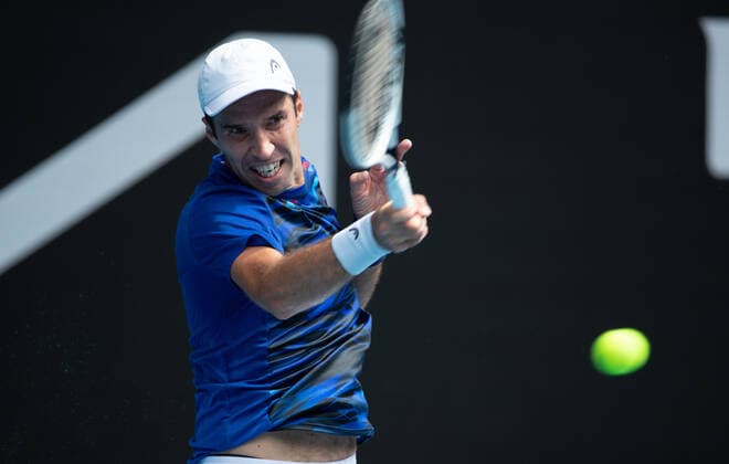 (210208) -- MELBOURNE, Feb. 8, 2021 -- Mikhail Kukushkin returns a shot during the men s singles first round match between Dominic Thiem of Austria and Mikhail Kukushkin of Kazakhstan in Melbourne Park, Melbourne, Australia on Feb. 8, 2021. (Photo by Xinhua) (SP)AUSTRALIA-MELBOURNE-TENNIS-AUSTRALIAN OPEN HuxJingchen 