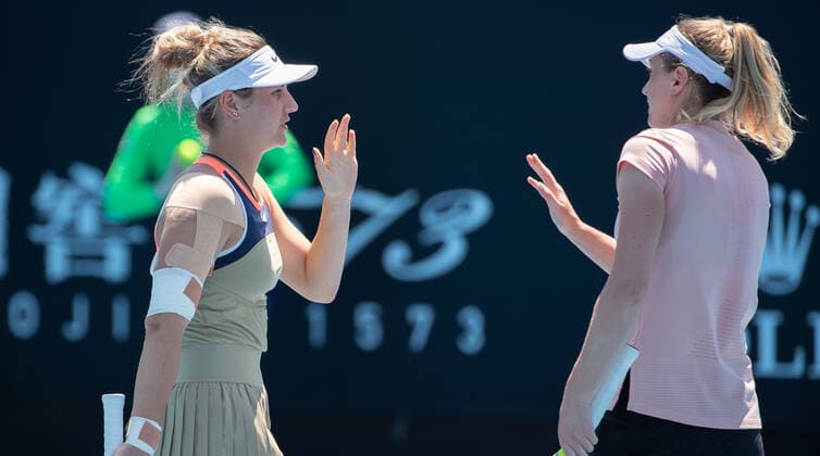 (210210) -- MELBOURNE, Feb. 10, 2021 -- Aliaksandra Sasnovich Marta Kostyuk (R) react during the women s doubles first round match between Zhu Lin (China) Mona Barthel (Germany) and Aliaksandra Sasnovich (Belarus) Marta Kostyuk (Ukraine) at the Australian Open in Melbourne Park, Melbourne, Australia on Feb. 10, 2021. (Photo by Xinhua) (SP)AUSTRALIA-MELBOURNE-TENNIS-AUSTRALIAN OPEN-DAY 3 HuxJingchen 