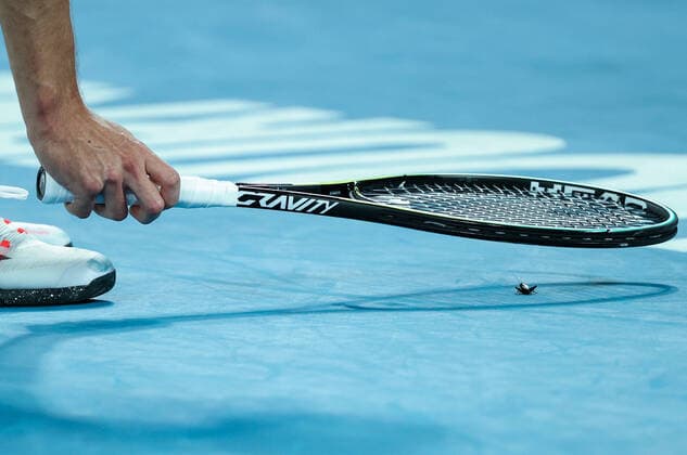 (210210) -- MELBOURNE, Feb. 10, 2021 -- Alexander Zverev of Germany attempts to catch a cricket during the men s singles match against Maxime Cressy of the United States at Australian Open in Melbourne Park, in Melbourne, Australia, on Feb. 10, 2021. ) (SP)AUSTRALIA-MELBOURNE-TENNIS-AUSTRALIAN OPEN-DAY 3 BaixXuefei 