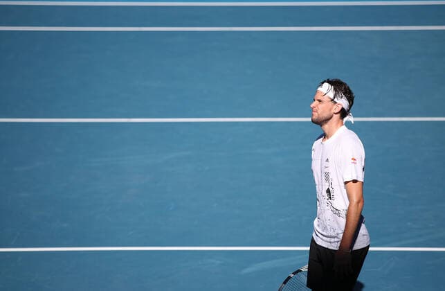 (210214) -- MELBOURNE, Feb. 14, 2021 -- Dominic Thiem reacts during the men s singles 4th round match between Dominic Thiem of Austria and Grigor Dimitrov of Bulgaria at the Australian Open 2021 tennis tournament in Melbourne Park, Melbourne, Australia, on Feb. 14, 2021. Bai Xuefei) (SP)AUSTRALIA-MELBOURNE-TENNIS-AUSTRALIAN OPEN-DAY 7 BaixXuefeihujingchen 