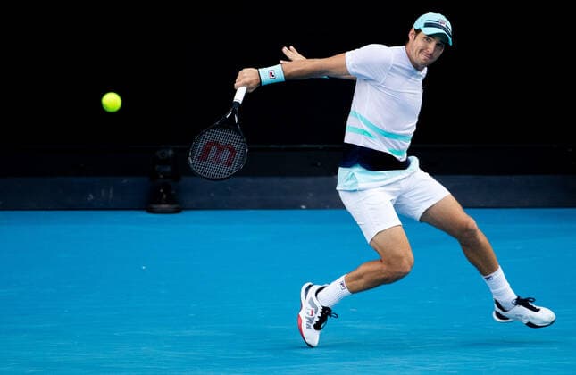 (210214) -- MELBOURNE, Feb. 14, 2021 -- Dusan Lajovic hits a return during the men s singles 4th round match between Alexander Zverev of Germany and Dusan Lajovic of Serbia at the Australian Open 2021 tennis tournament in Melbourne Park, Melbourne, Australia, on Feb. 14, 2021 (Photo by Xinhua) (SP)AUSTRALIA-MELBOURNE-TENNIS-AUSTRALIAN OPEN-DAY 7 HuxJingchen 