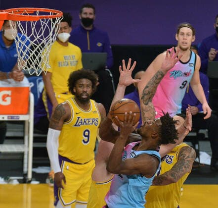 Miami Heat guard Jimmy Butler scores over Los Angeles Lakers forward Kyle Kuzma during the second half at Staples Center in Los Angeles on Saturday, February 20, 2021. The Heat defeated the Lakers 96-94.  LAP2021022006 JIMxRUYMEN