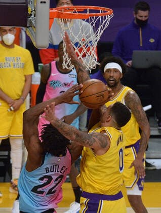 Miami Heat guard Jimmy Butler scores over Los Angeles Lakers forward Kyle Kuzma during the second half at Staples Center in Los Angeles on Saturday, February 20, 2021. The Heat defeated the Lakers 96-94.  LAP2021022014 JIMxRUYMEN