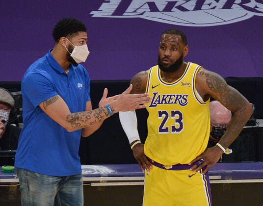 Los Angeles Lakers forward Anthony Davis goes over a play on the sidelines with teammate LeBron James during a break in the game against the Miami Heat in the second half of the Lakers 96-94 loss at Staples Center in Los Angeles on Saturday, February 20, 2021. Lakers coach Frank Vogel says Davis will miss an estimated four weeks due to a calf sprain. Davis recently missed a few games because of Achilles tendinosis.  LAP2021022022 JIMxRUYMEN
