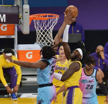 Los Angeles Lakers center Montrezl Harrell scores on Miami Heat forward Precious Achiuwa during the first half of the Lakers 96-94 loss at Staples Center in Los Angeles on Saturday, February 20, 2021.  LAP2021022025 JIMxRUYMEN