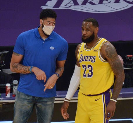 Los Angeles Lakers forward Anthony Davis goes over a play on the sidelines with teammate LeBron James during a break in the game against the Miami Heat in the second half of the Lakers? 96-94 loss at Staples Center in Los Angeles on Saturday, February 20, 2021. Lakers coach Frank Vogel says Davis will miss an estimated four weeks due to a calf sprain. Davis recently missed a few games because of Achilles tendinosis.  LAP2021022029 JIMxRUYMEN
