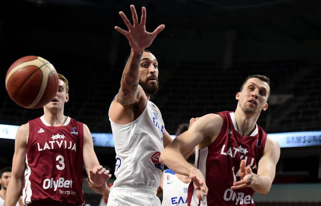 (210223) -- RIGA, Feb. 23, 2021 -- Artis Ate (R) of Latvia vies with Linos Chrysikopoulos (C) of Greece during the FIBA EuroBasket 2022 qualifying basketball match between Latvia and Greece in Riga, Latvia, Feb. 22, 2021. (Photo by Xinhua) (SP)LATVIA-RIGA-BASKETBALL-FIBA EUROBASKET 2022 QUALIFIERS-LATVIA VS GREECE EdijsxPalens 