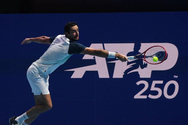 (210227) -- SINGAPORE Feb. 27, 2021 -- Marin Cilic hits a return during the men s singles semi-final match between Croatia s Marin Cilic and Australia s Alexei Popyrin at the Singapore Tennis Open tournament in Singapore on Feb. 27, 2021. (Photo by Xinhua) (SP)SINGAPORE-TENNIS-SINGAPORE OPEN-MEN S SINGLES ThenxChihxWey 