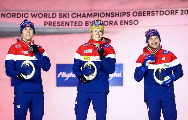 OBERSTDORF, GERMANY - FEBRUARY 27, 2021: Silver medalist Erik Valnes, gold medalist Johannes Hoesflot Klaebo, and bronze medalist Haavard Solaas Taugboel (L-R) of Norway during an award ceremony for the men s classic sprint event at the 2021 FIS Nordic World Ski Championships. Sergei Bobylev TASS  TS0F807D