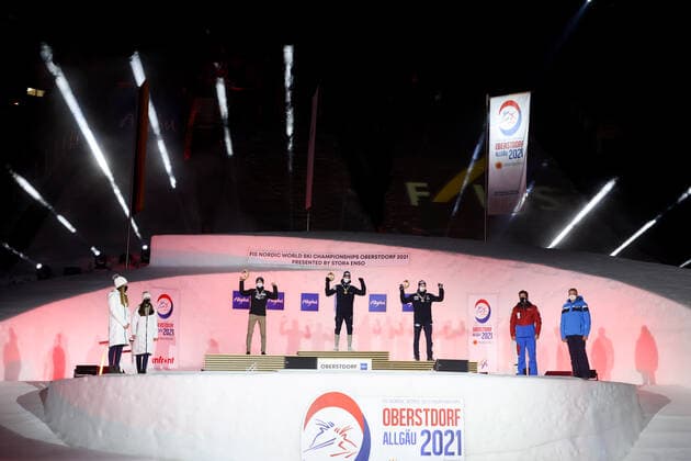 NORDIC SKIING - FIS Nordic World Ski Championships Oberstdorf 2021 OBERSTDORF,GERMANY,27.FEB.21 - NORDIC SKIING, NORDIC COMBINED - FIS Nordic World Ski Championships, men, award ceremony. Image shows the rejoicing of Ilkka Herola (FIN), Jarl Magnus Riiber and Jens Luraas Oftebro (NOR). GEPAxpictures xChristianxWalgram